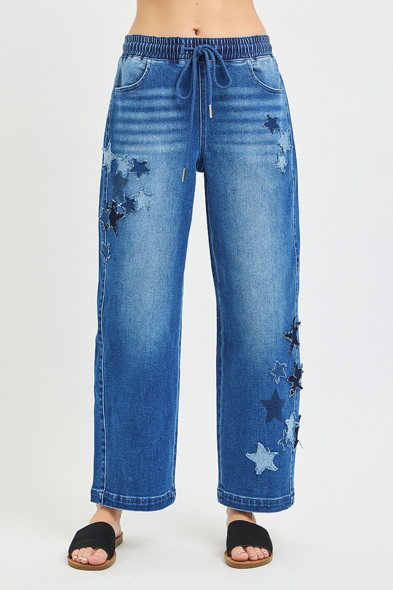 Cropped barrel jeans in medium-wash denim with elastic drawstring waist and star patches