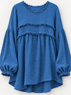 Blue peplum blouse front view with layered frayed bands and gathered cuff sleeves