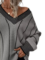 Gray textured knit V-neck sweater with black contrast trim and long sleeves.