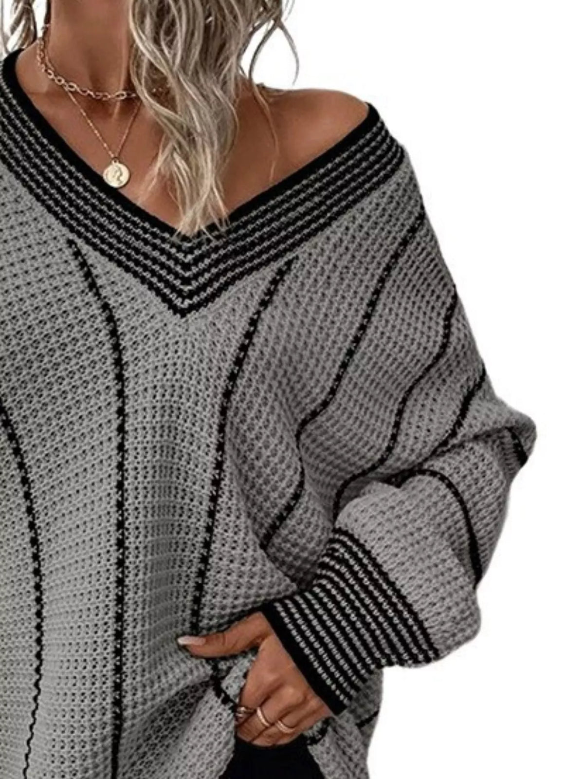 Gray textured knit V-neck sweater with black contrast trim and long sleeves.