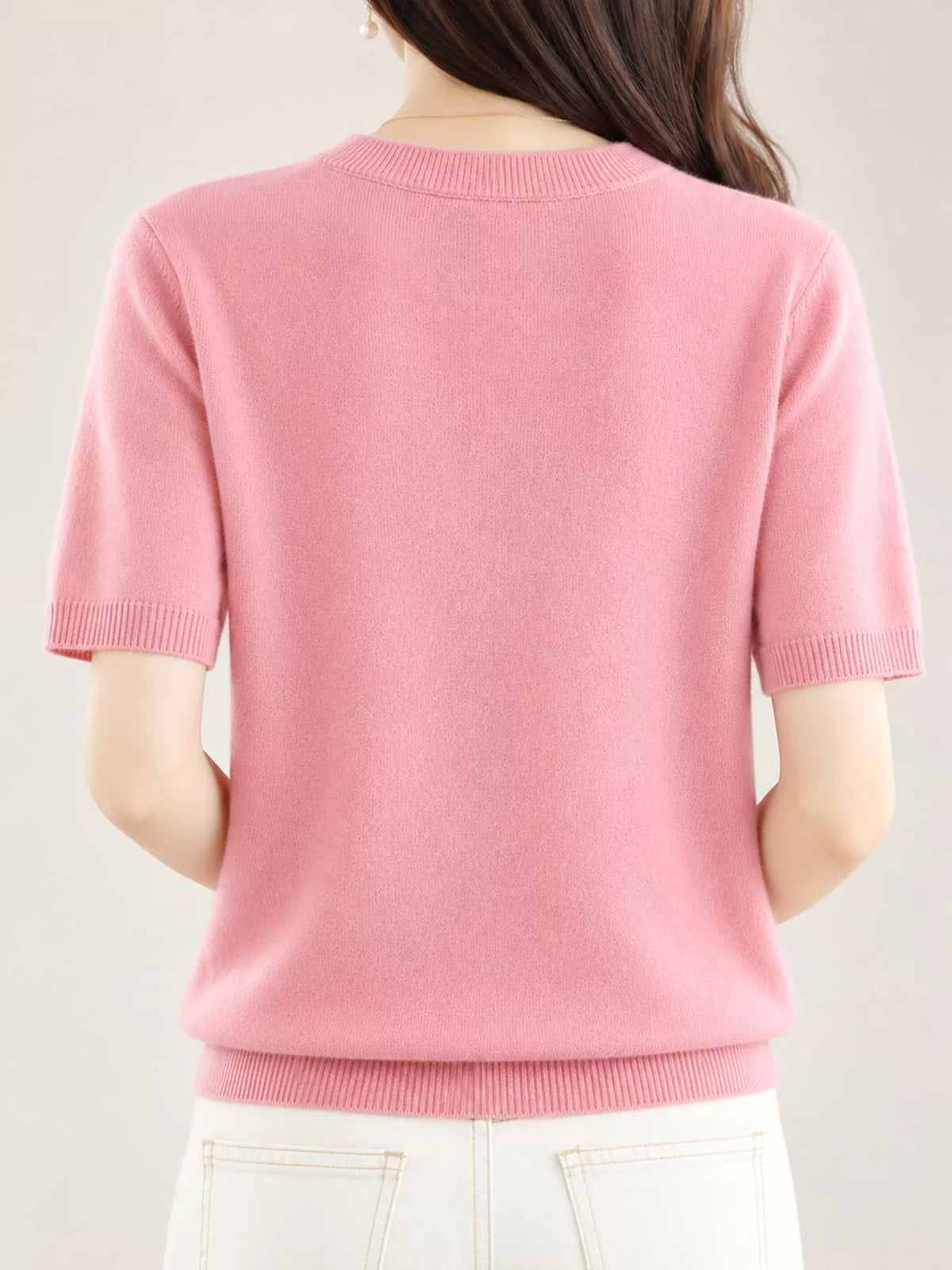Pink round-neck short-sleeve sweater, back view with ribbed hem and cuffs