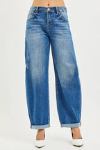 Dark wash mid-rise barrel jeans with double roll cuffs and button front