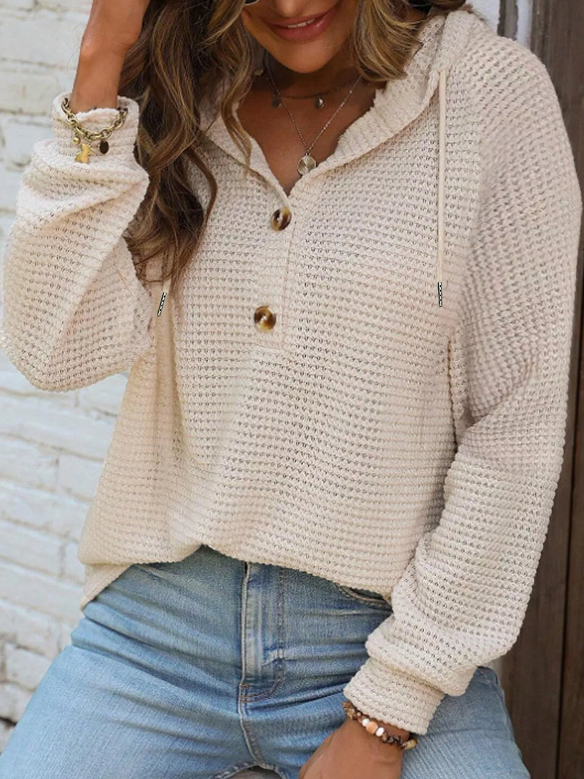 Cream waffle-knit button hoodie with hood, long sleeves, and drawstring details