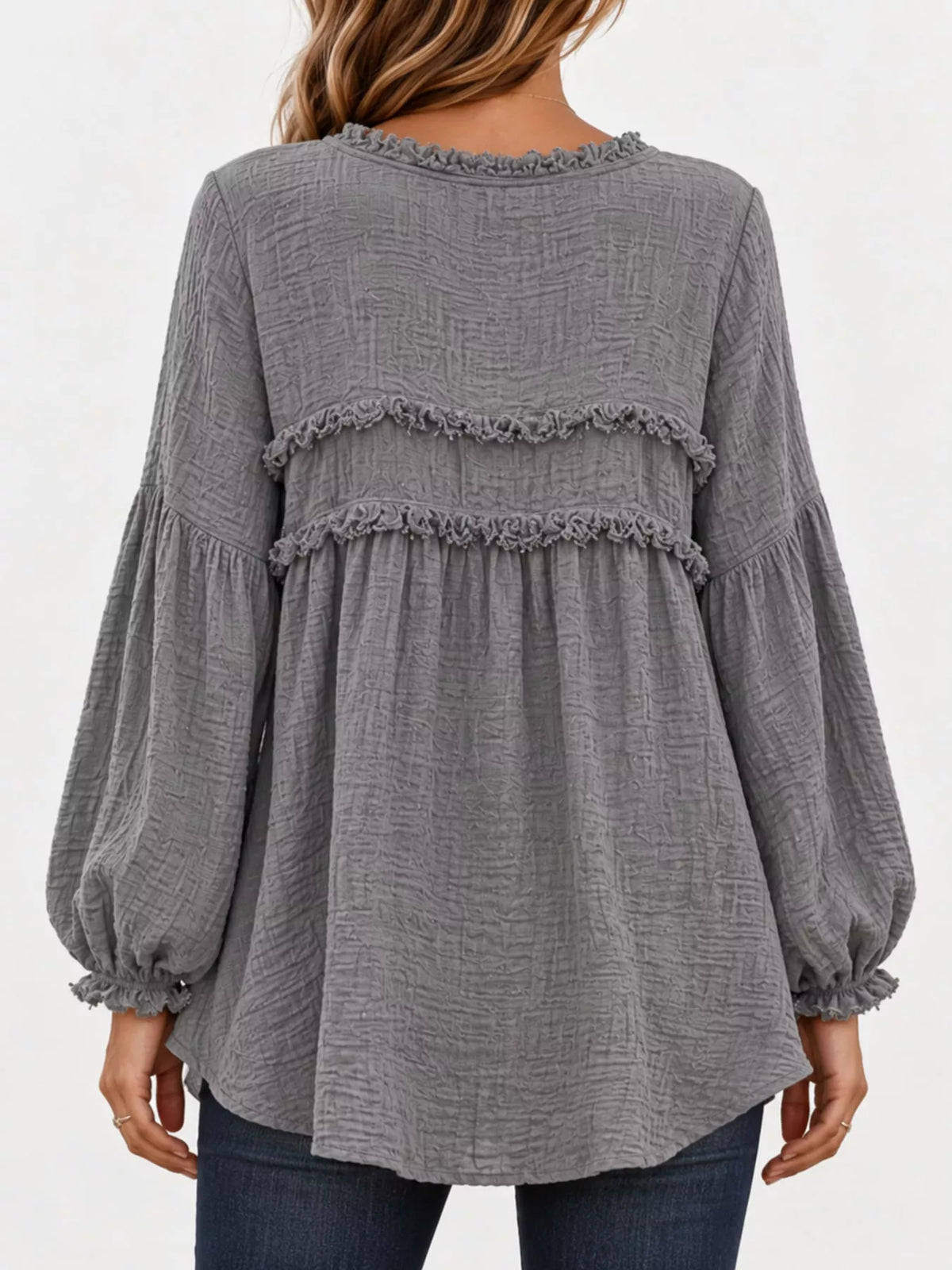 Gray peplum blouse with frayed ruffle yokes and long puff sleeves, back view