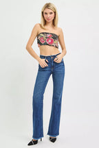 Women's dark blue mid-rise bootcut jeans with frayed waistband and hem detail