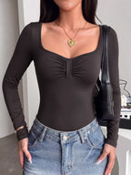 Ruched scoop-neck long-sleeve bodysuit with gathered center, dark fabric