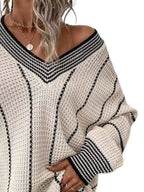 Cream textured knit V-neck sweater with black contrast striped trim and long sleeves.