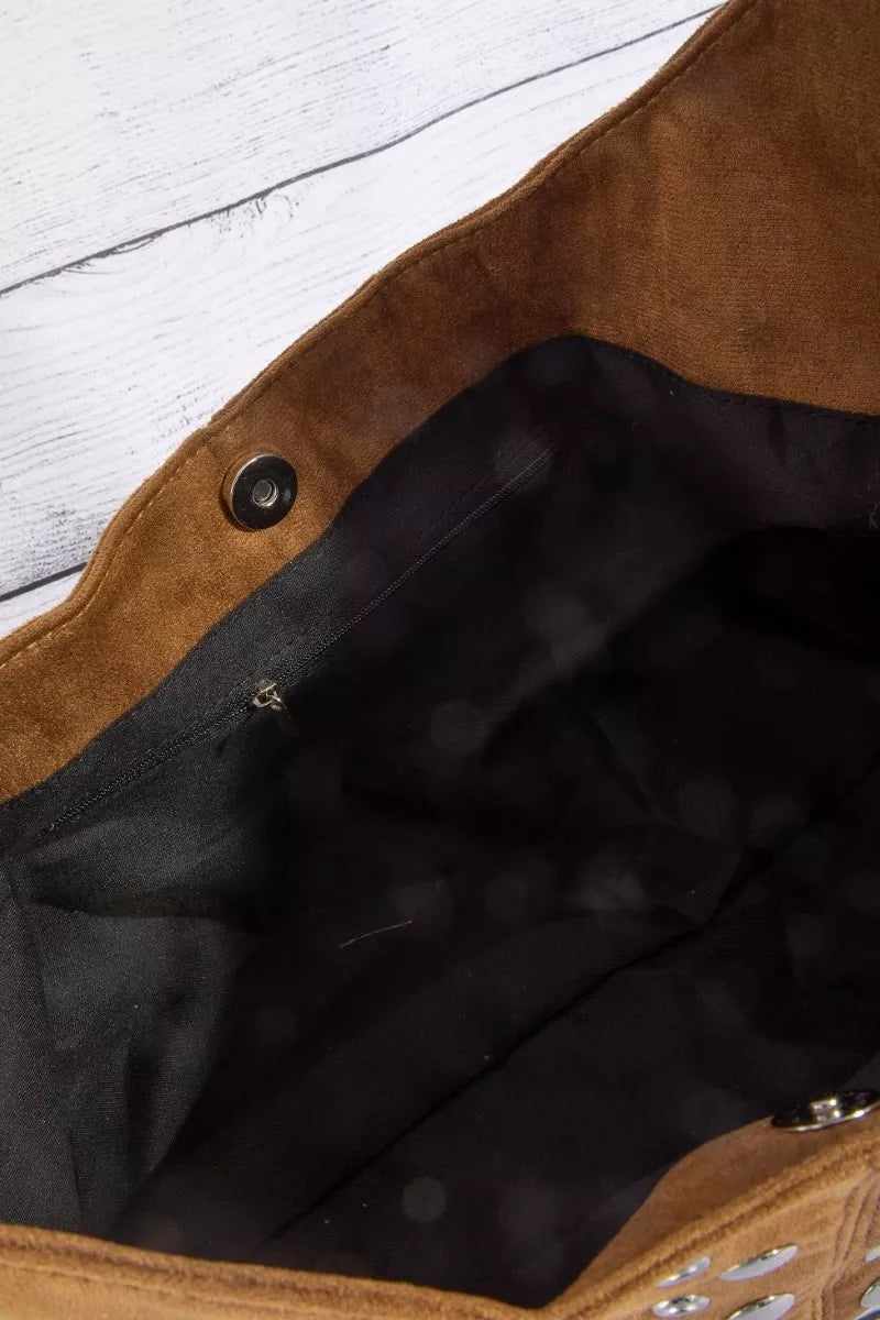 Studded shoulder bag interior with black fabric lining and a top snap