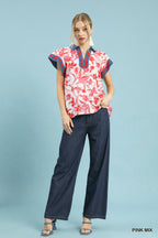 Floral flutter top with short sleeves, pink-and-white red blossom print, navy trim