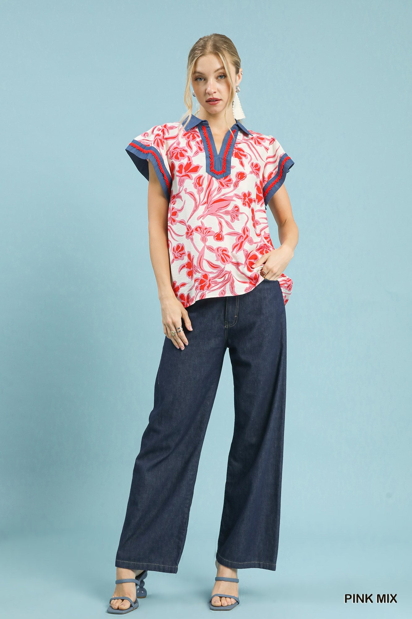 Floral flutter top with short sleeves, pink-and-white red blossom print, navy trim
