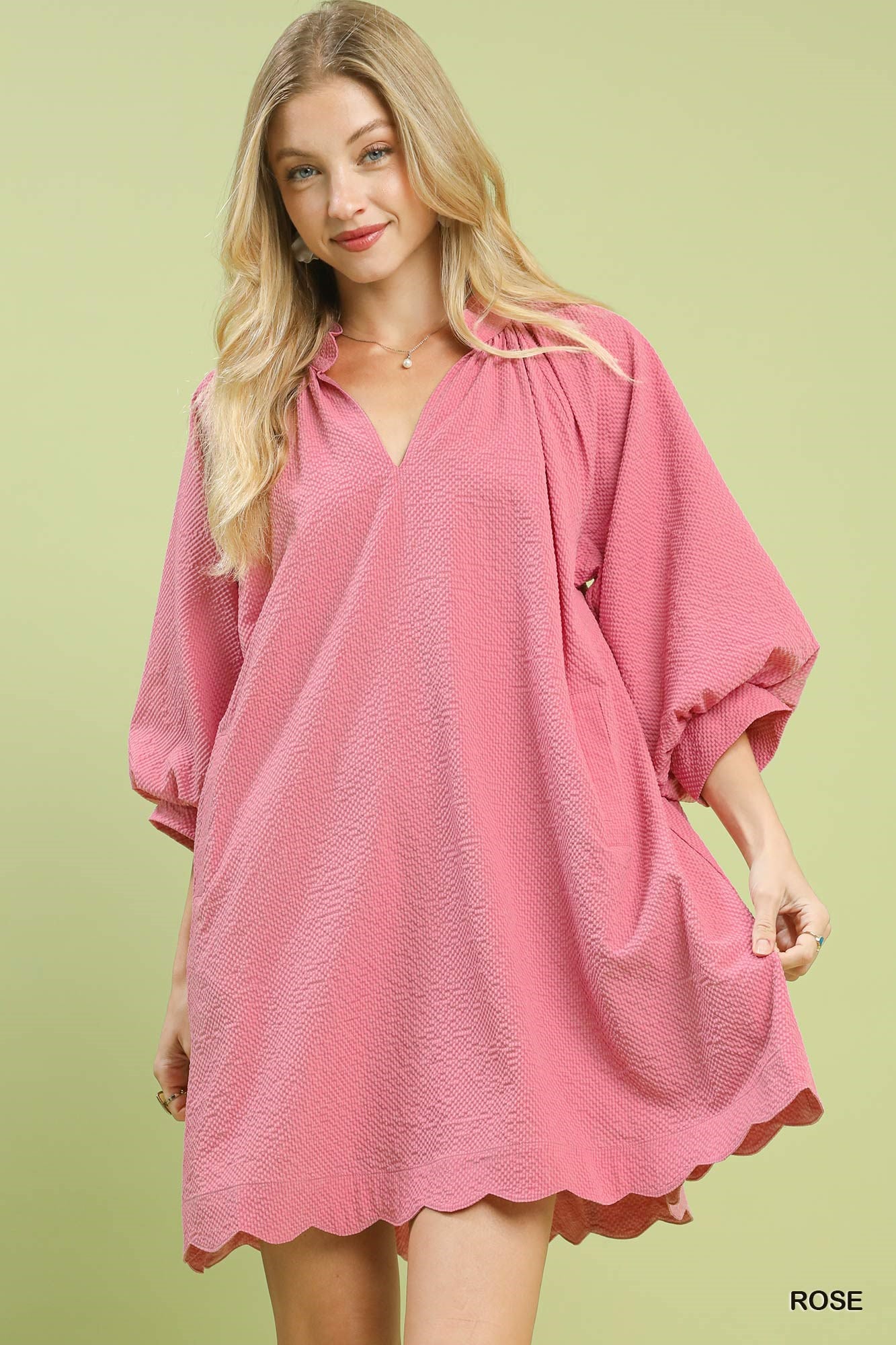 Rose pink textured mini dress with V-neck and balloon sleeves, scalloped hem