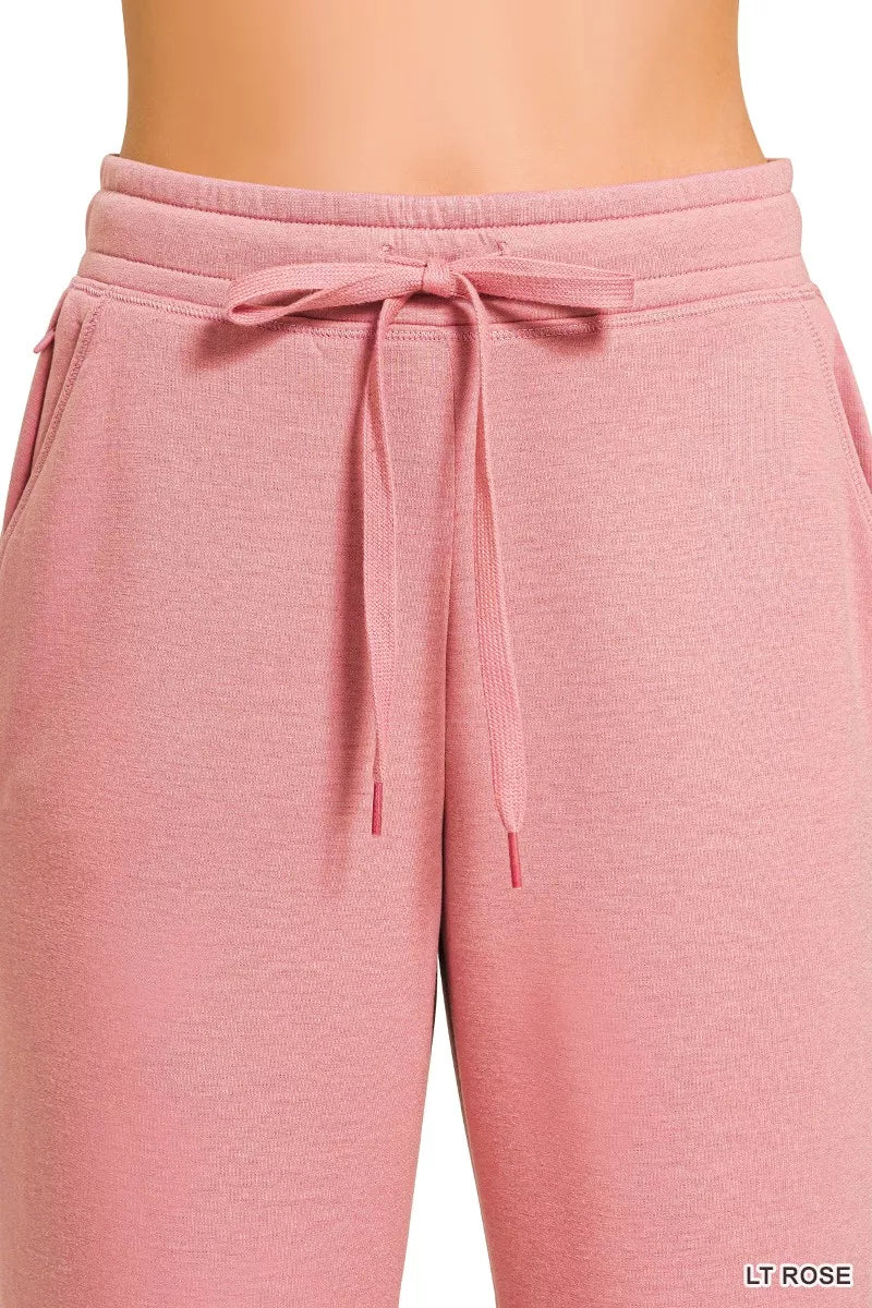 Light rose joggers with drawstring waist and looped tie