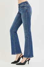 Medium wash low rise bootcut jeans, side view, flared hem and stitched leg seams