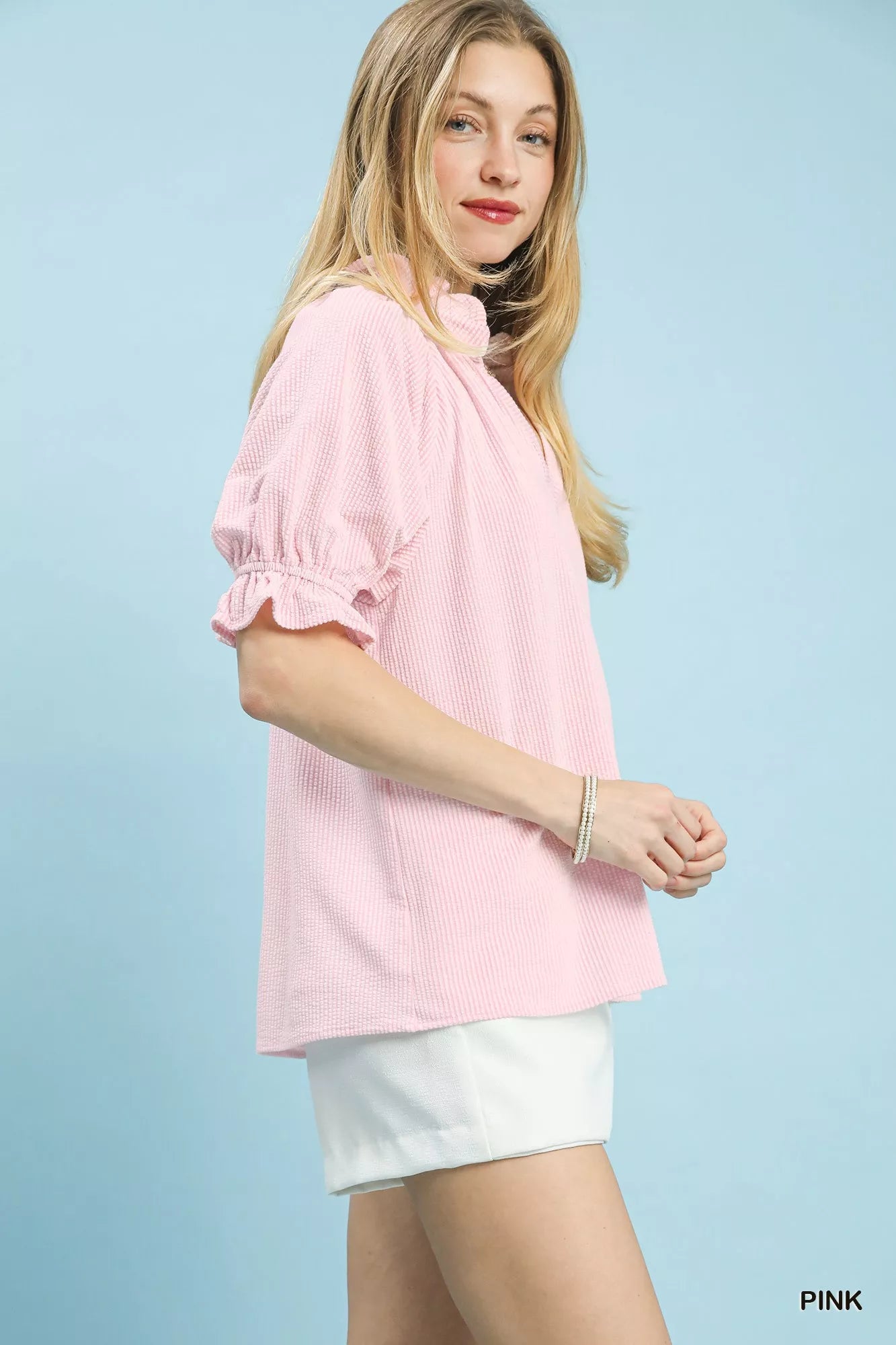 Pink textured blouse with ruffle sleeves, side view