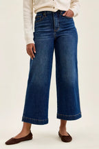Dark indigo wide-leg ankle jeans with button closure and front pockets