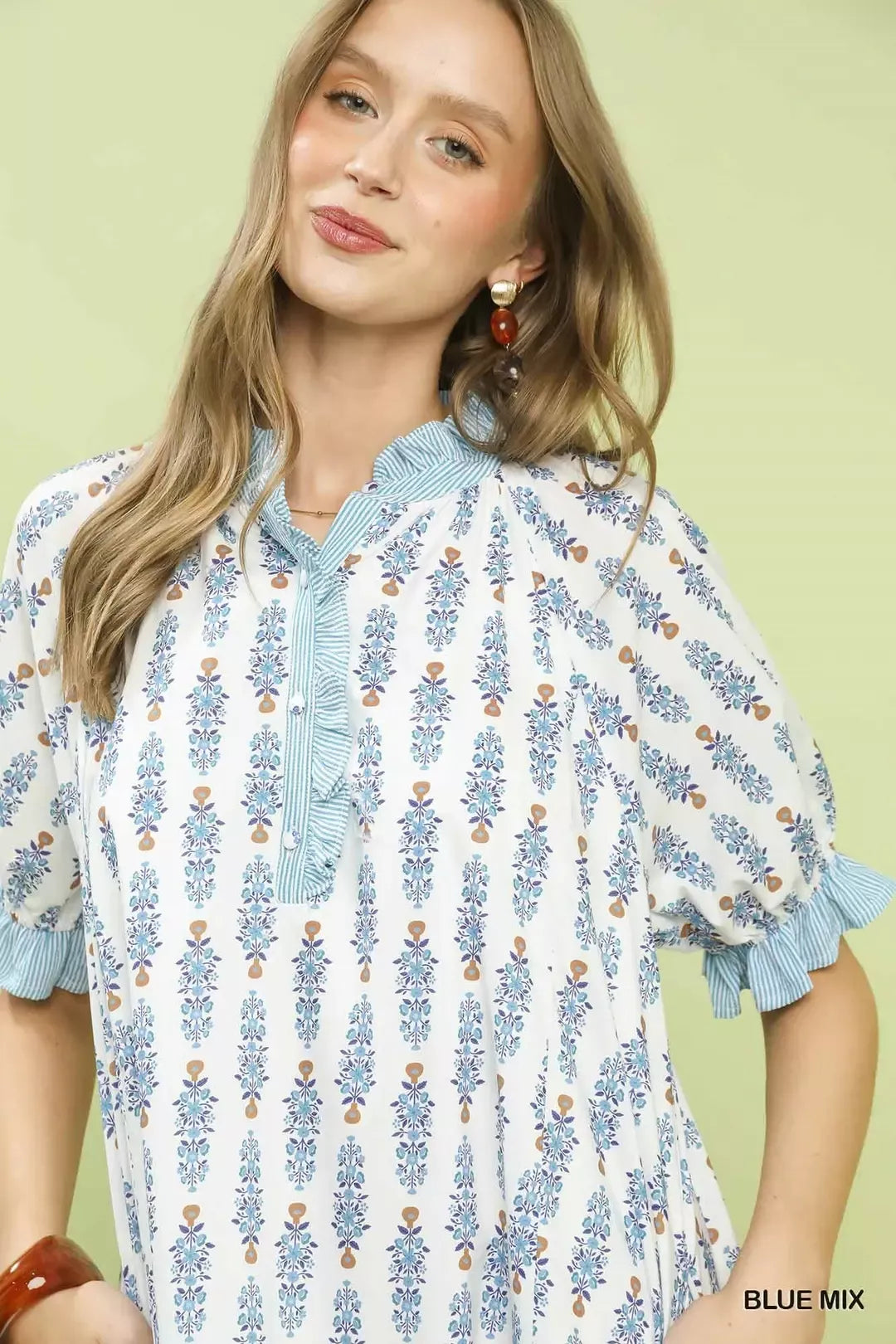 Light blue floral-print tiered mini dress close-up: button front and ruffled collar