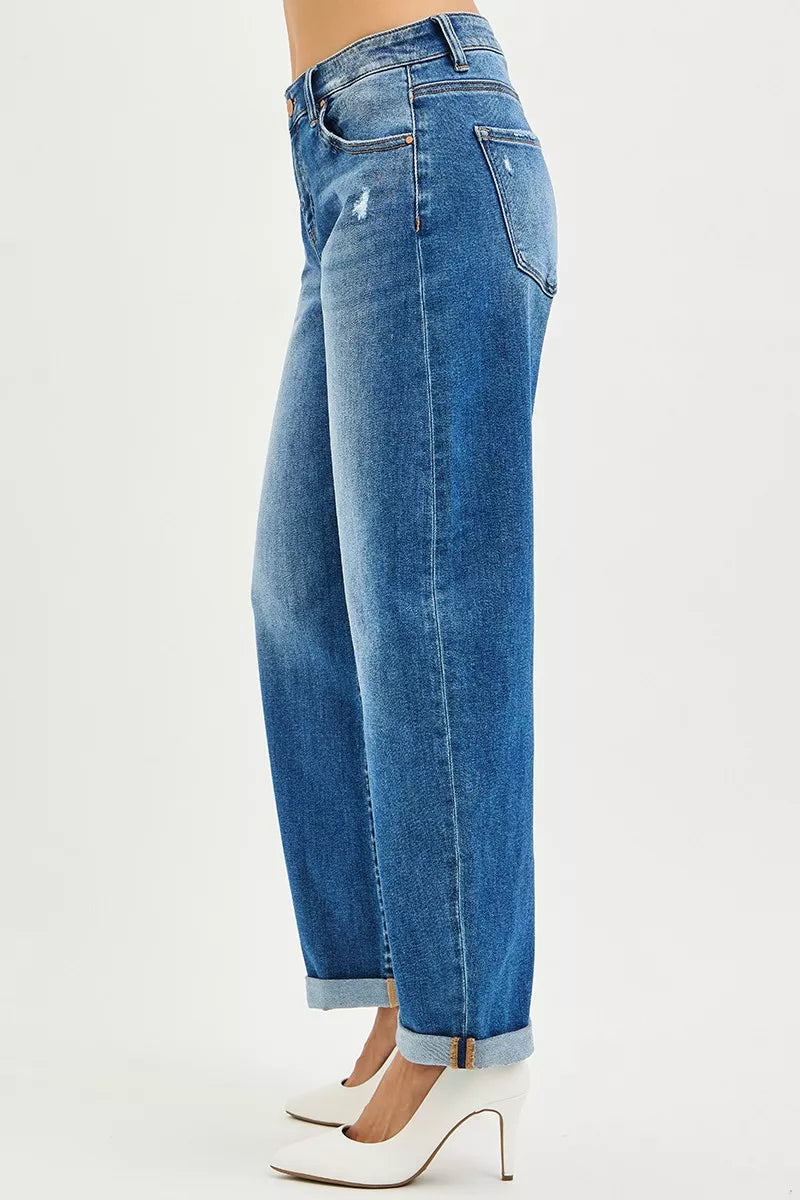 Dark wash mid-rise barrel jeans side view with cuffed hems and belt loops