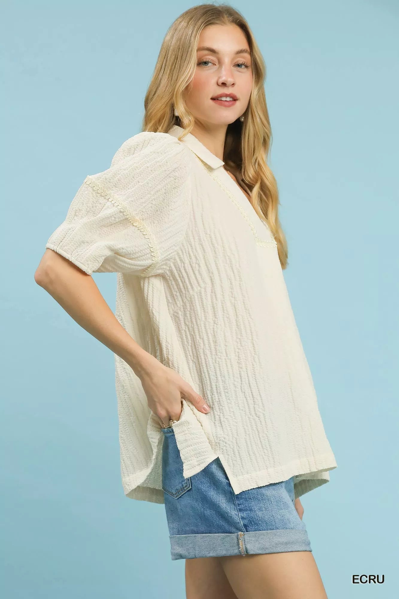 Ecru textured V-neck blouse with short puff sleeves and relaxed fit