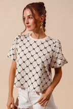Ivory textured woven top with black bow pattern, short puff bubble sleeves