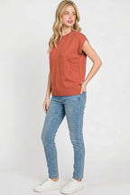 Rust ribbed cap sleeve crew neck pullover worn with blue jeans