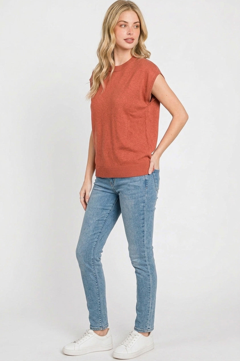 Rust ribbed cap sleeve crew neck pullover worn with blue jeans