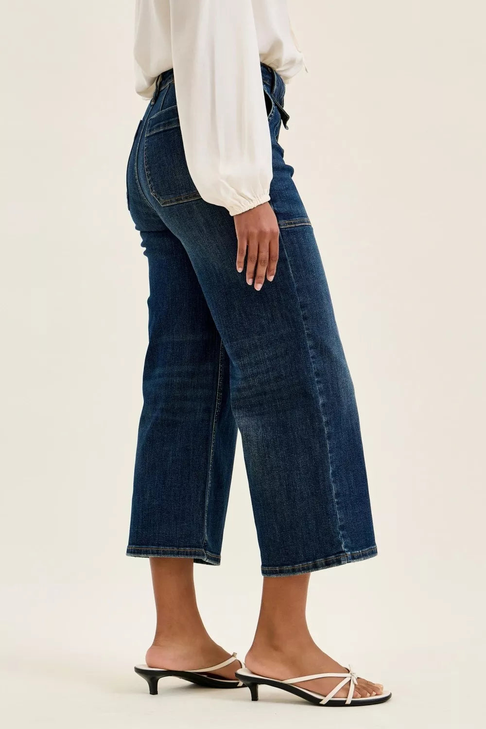Women’s high-waist wide-crop utility jeans, dark blue denim, side view with patch pocket