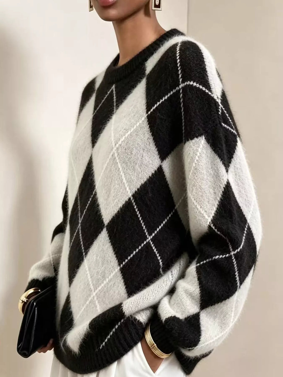 Fuzzy argyle knit sweater in black and cream with large diamond pattern and crew neck