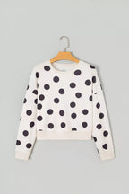 White kids’ sweatshirt with long sleeves and black polka dots; pullover crew neck