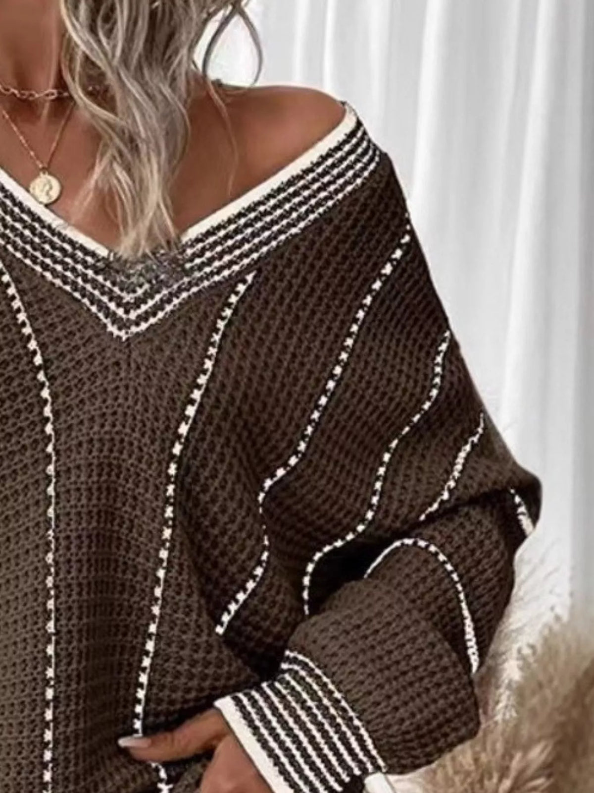 Brown V-neck textured knit sweater with white vertical stripes and ribbed cuff