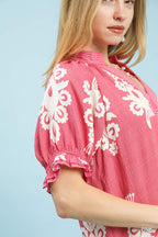 Pink mini dress sleeve detail with white floral print and ruffle cuff