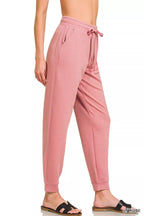 Light rose drawstring scuba joggers with side pockets and tapered cuffs