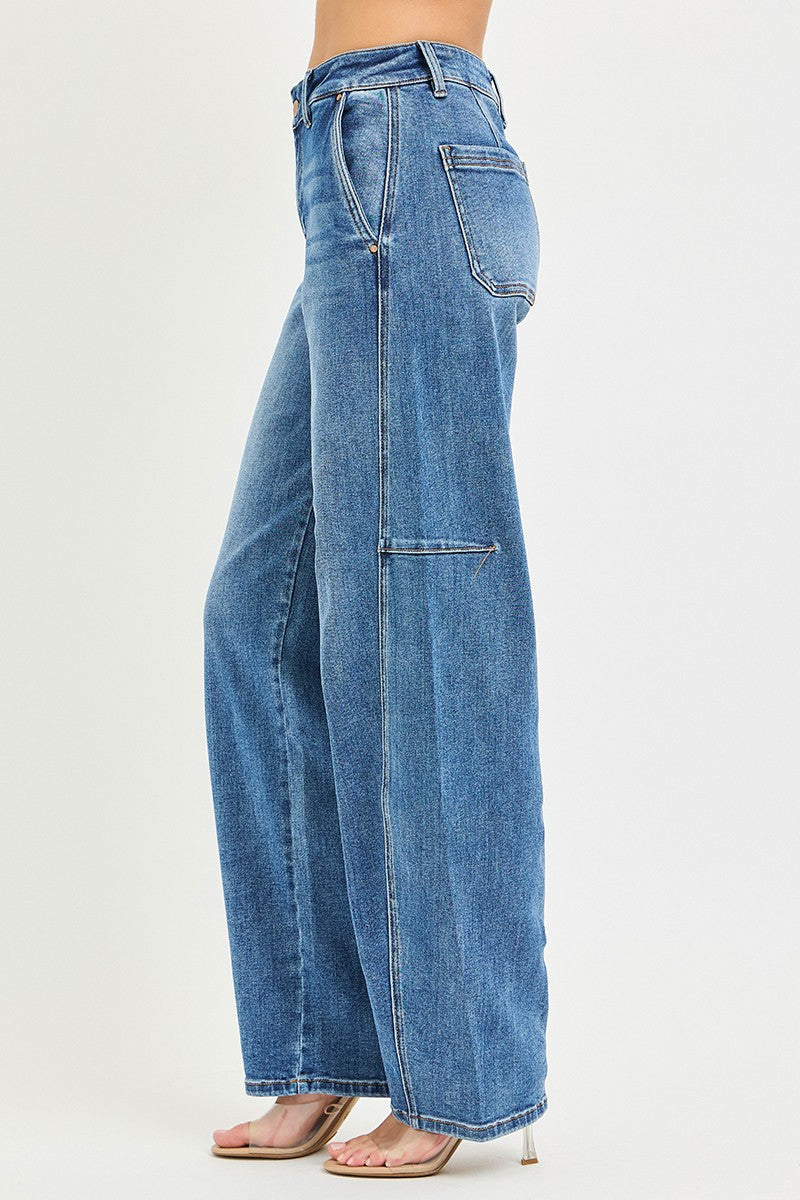 Medium-wash baggy jeans side view with button fly, pockets, and relaxed wide leg