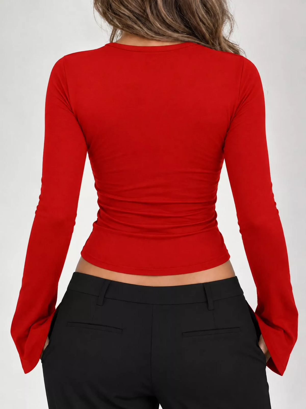 Red V-neck long sleeve tee with ruched back, flared sleeves, rear view