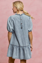 Light-wash denim mini dress, back button placket, puff sleeves, tiered skirt