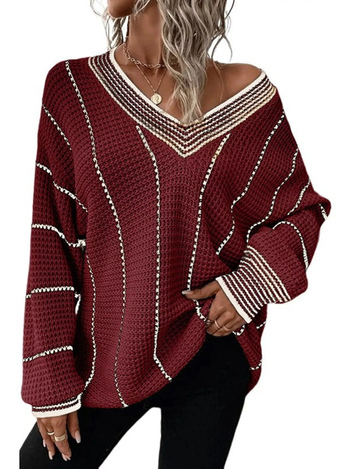 Burgundy textured knit V-neck sweater with cream contrast stripes and long sleeves.