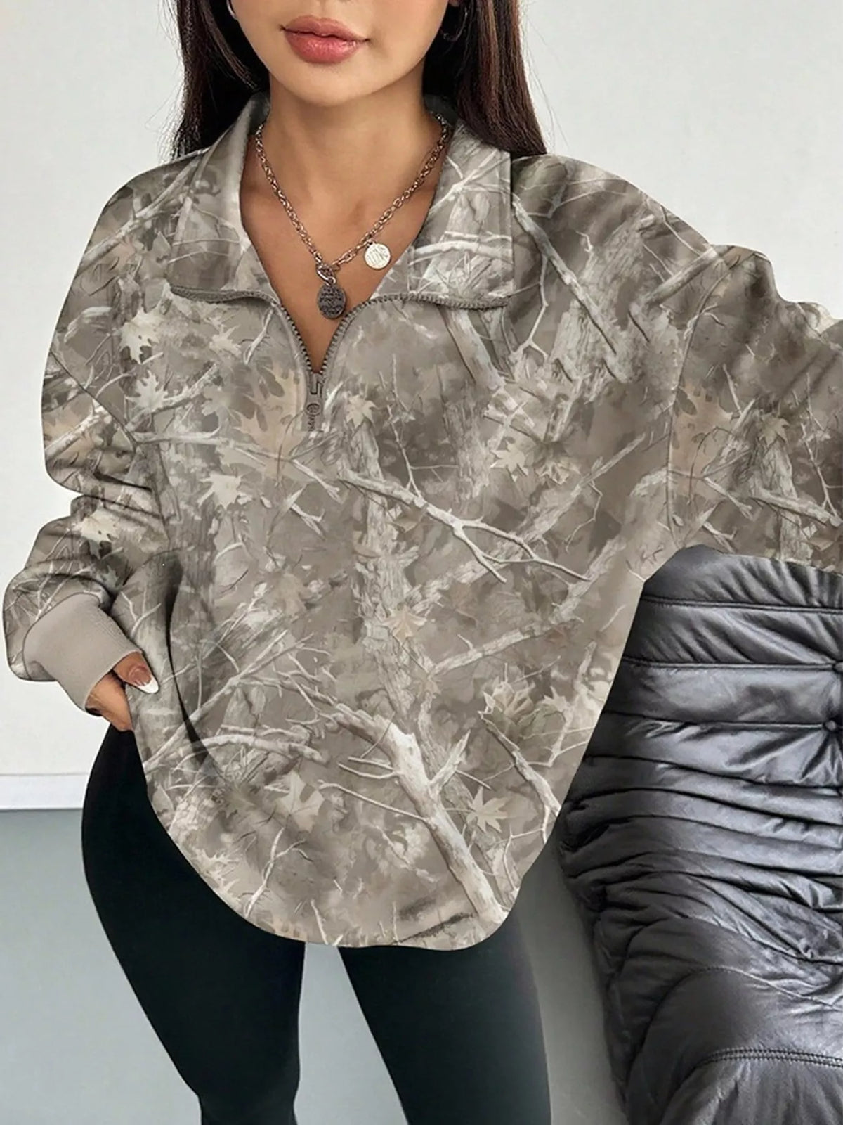 Light gray camo zip-neck oversized sweatshirt with front half-zip and long sleeves