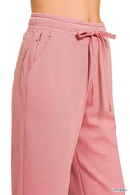 Light rose joggers with drawstring waist and angled back pocket detail