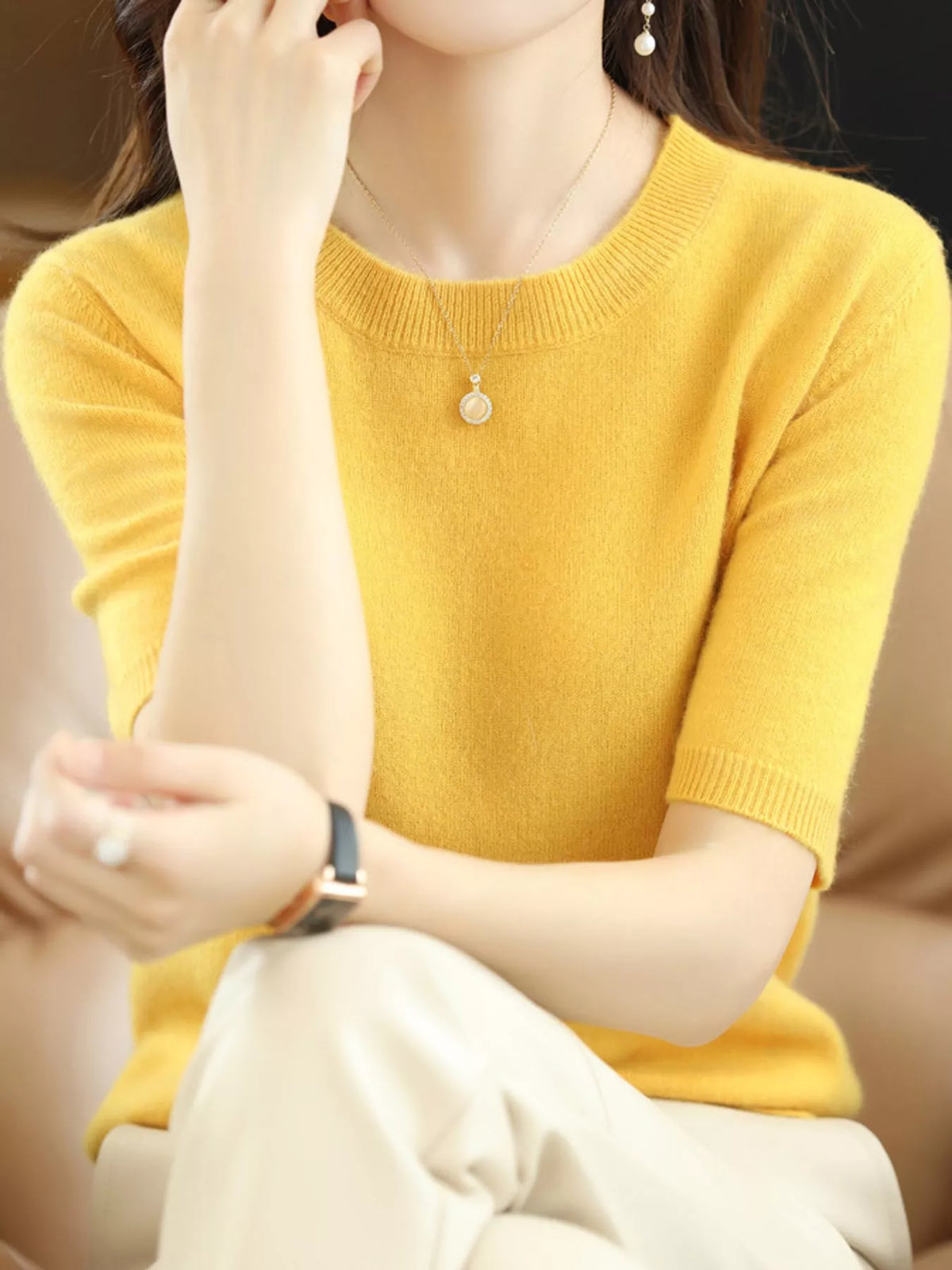 Bright yellow round-neck short-sleeve knit sweater with ribbed cuffs
