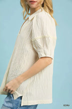 Ecru textured puff-sleeve blouse with gathered neckline and embroidered-look texture