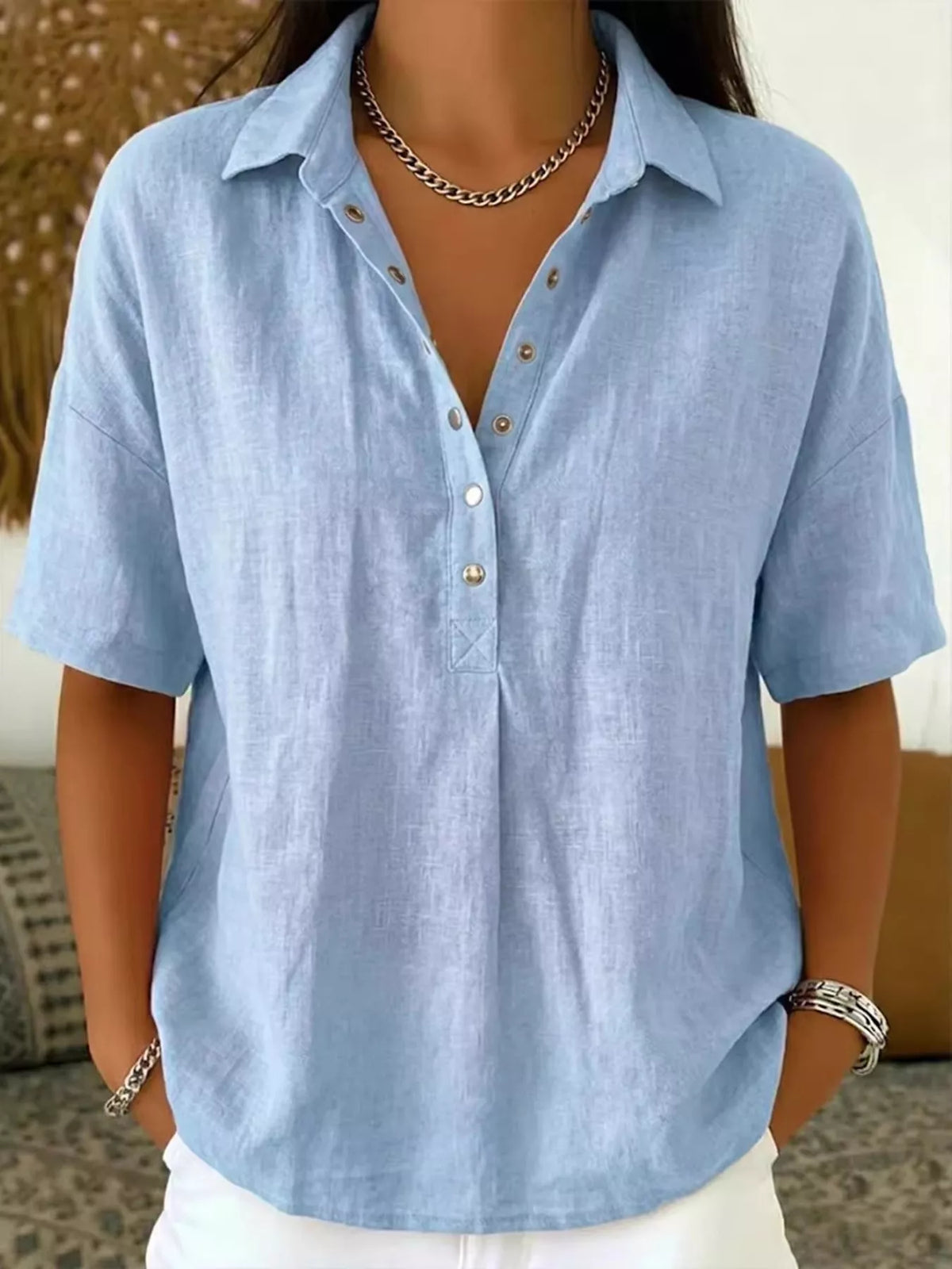 Light blue short-sleeve snap-front shirt with collared V-neck and snap buttons