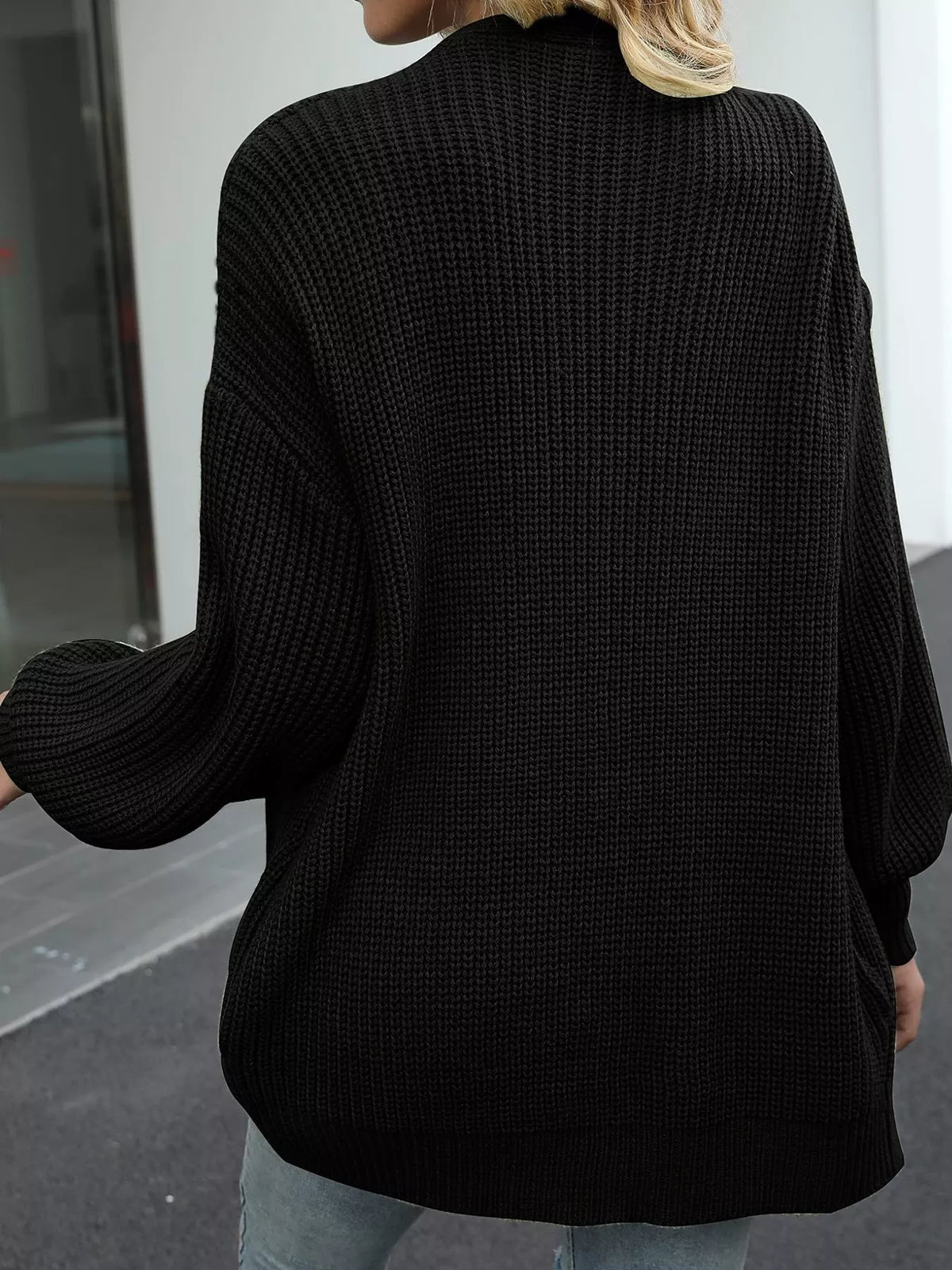 Black chunky knit cardigan back view with ribbed texture and wide sleeves