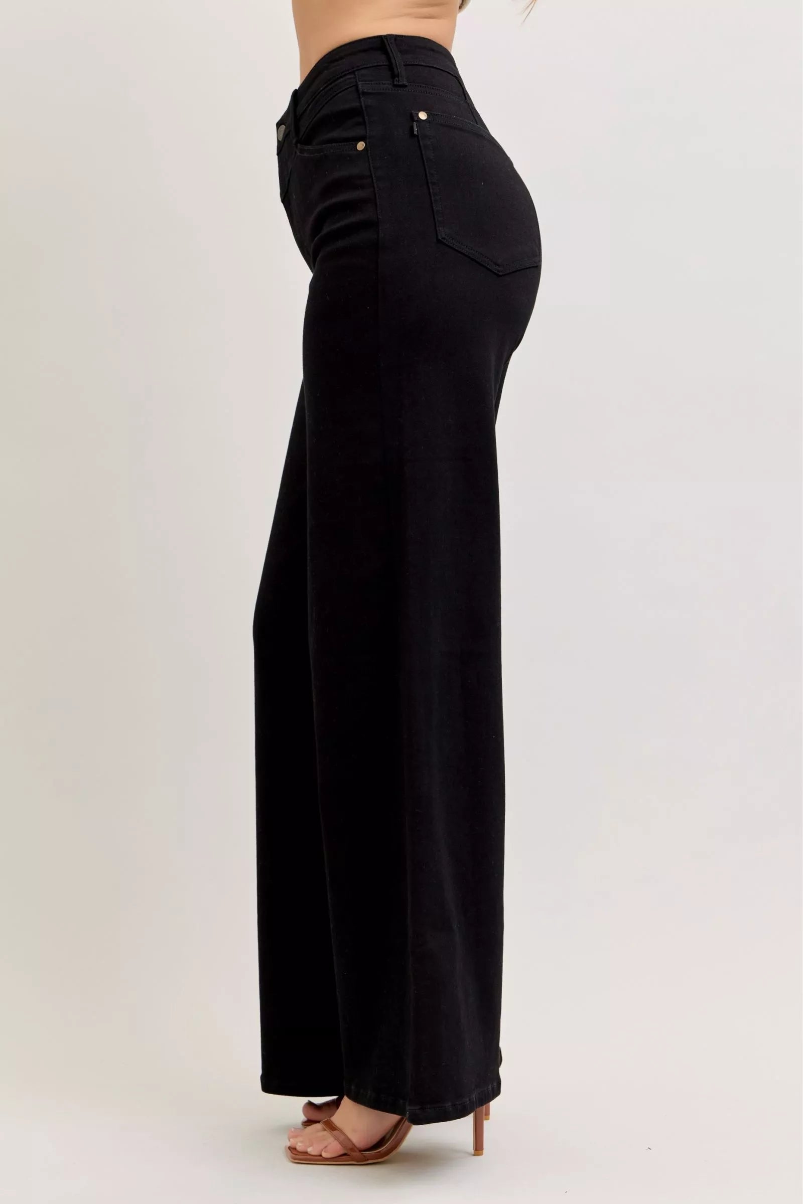 High-waisted wide-leg black denim jeans, side view with front pocket and stitched seams