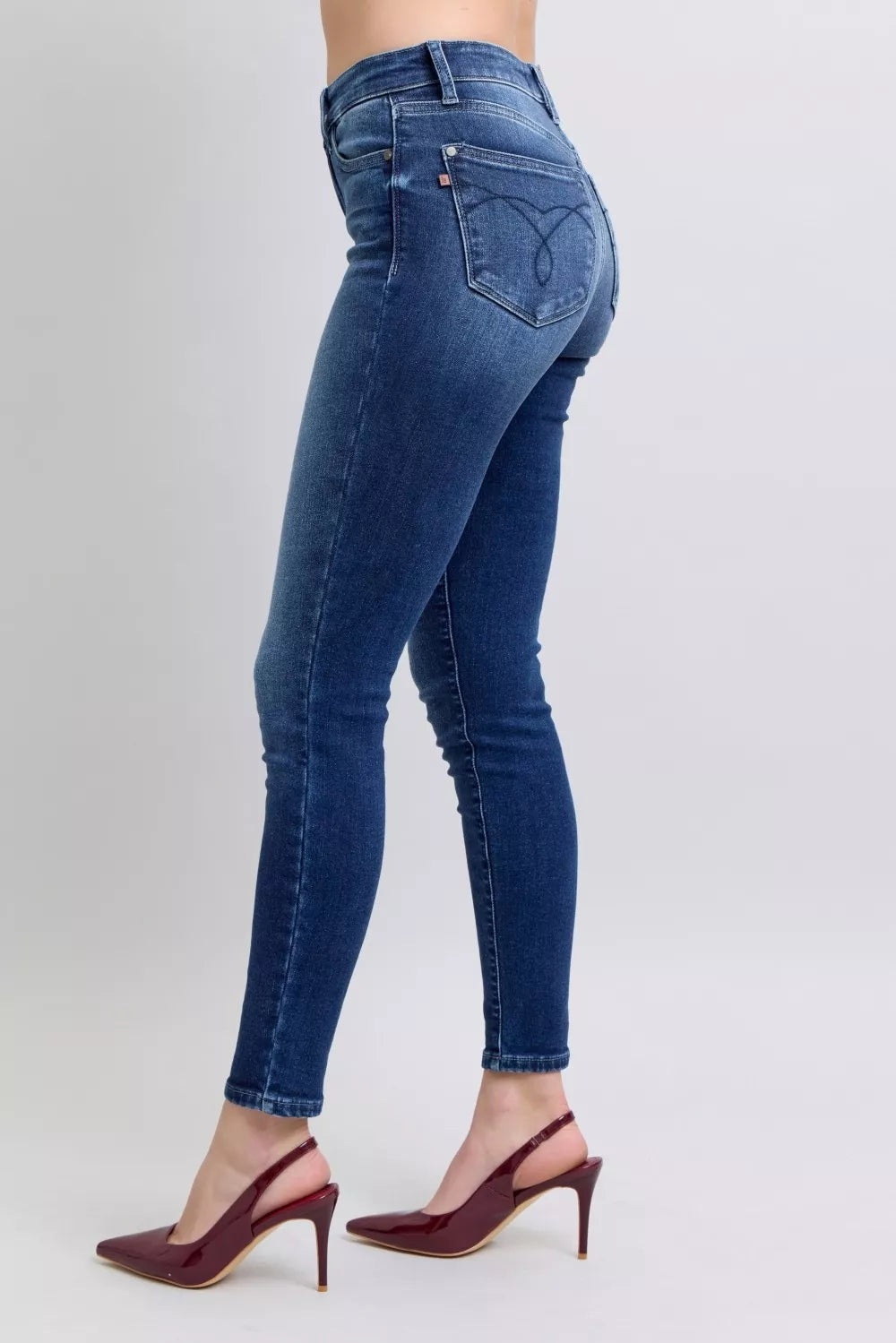 Washed dark blue skinny jeans, back patch pockets, stitched panel seams