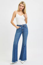 Women’s mid-rise flare jeans in blue denim, frayed hem and front button closure