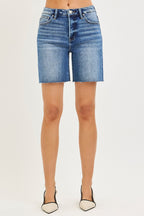 Medium-wash high-rise denim shorts with raw hem and classic five-pocket styling.