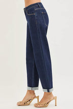 Dark blue cropped boyfriend jeans side view with cuffed hem and belt loops