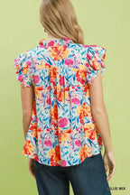 Back view of floral blouse with smocked yoke and ruffle sleeves, blue base floral print