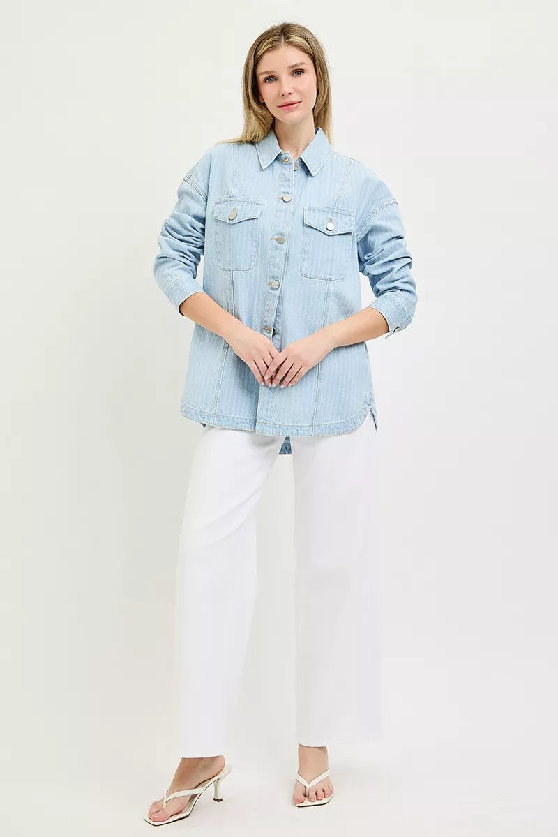Light blue denim shacket with button front and flap chest pockets over white pants