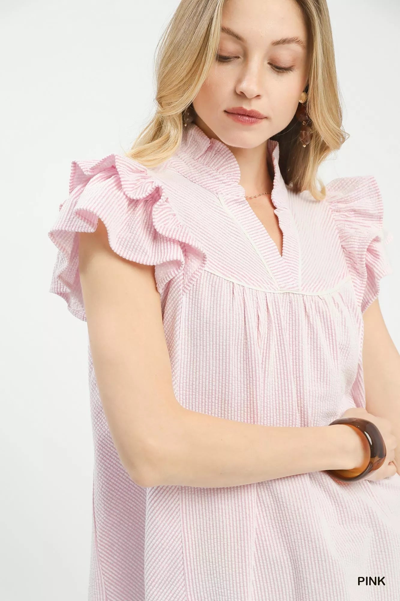 Pink textured blouse with ruffled shoulder sleeves and gathered V neckline