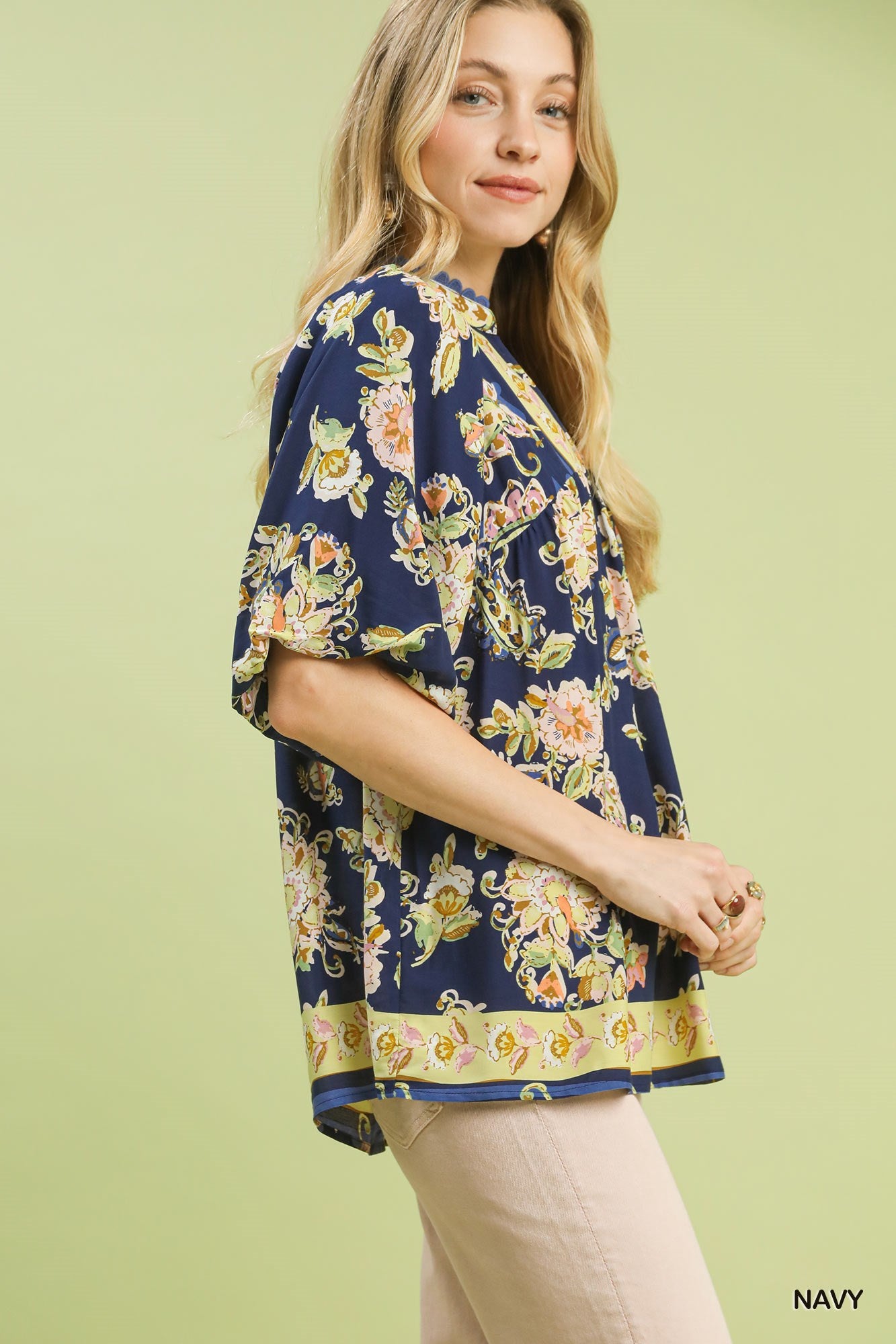 Navy floral boho rayon blouse with V-neck and short flutter sleeves, side view